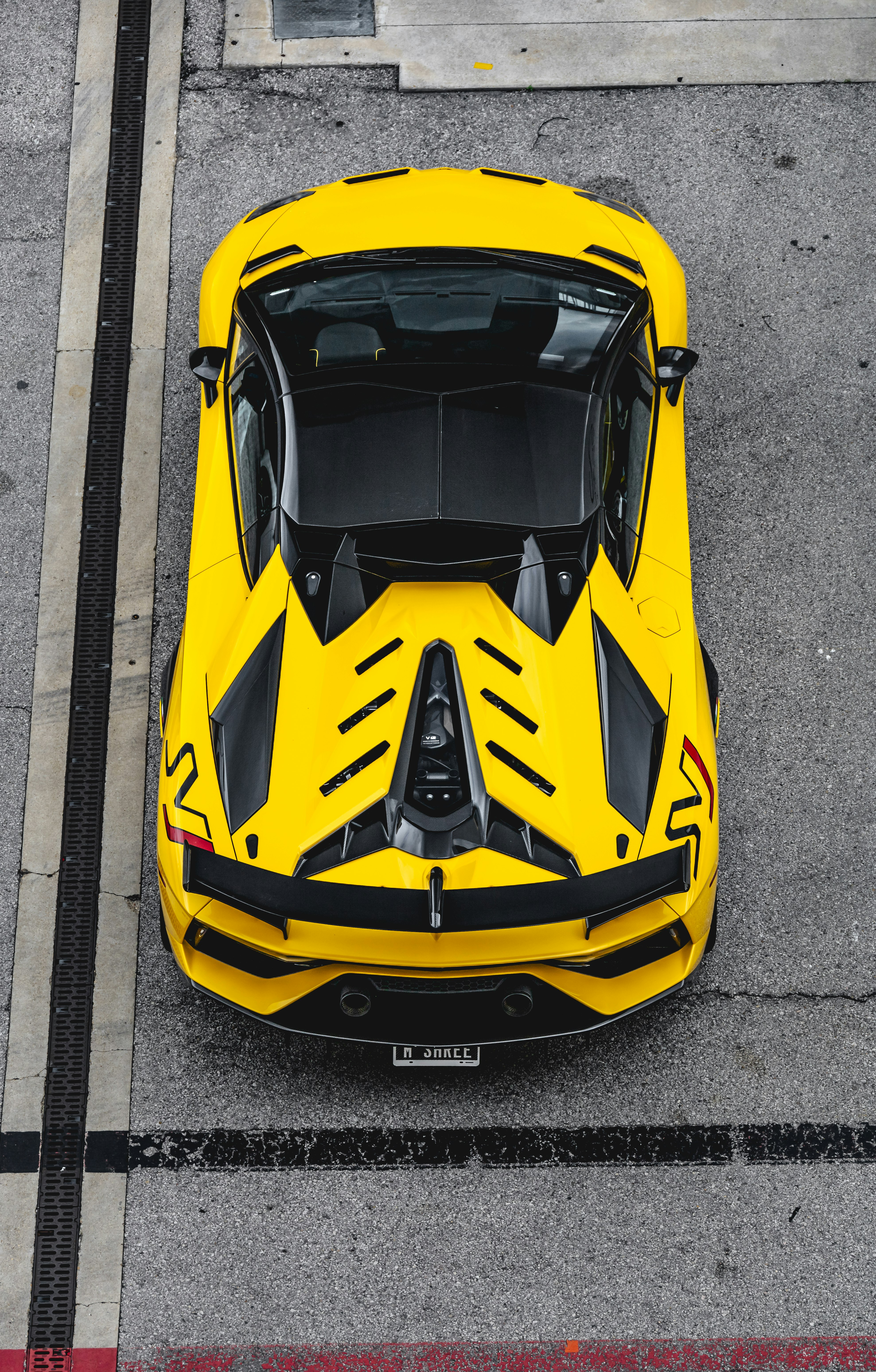 yellow and black lamborghini aventador parked on gray concrete road during daytime